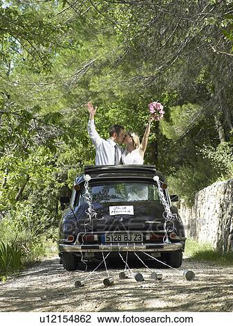 Bride and groom kissing in wedding car View Large Photo Image Stock Image - Bride and groom kissing in wedding car. Fotosearch