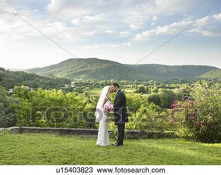 Stock Image - Bride and groom kissing. Fotosearch