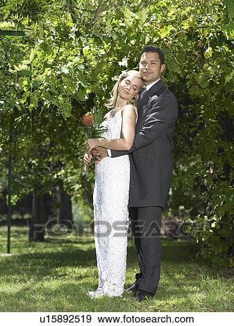 Bride relaxing against groom View Large Photo Image Stock Photo - Bride relaxing against groom. Fotosearch
