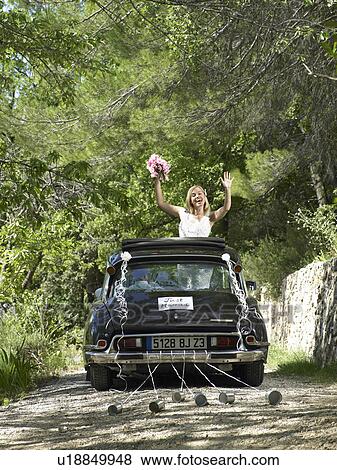 Bride waving from wedding car View Large Photo Image Stock Photo - Bride waving from wedding car. Fotosearch