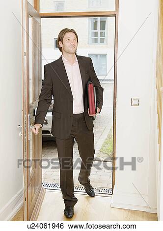 Stock Photograph - Business man arrives home. Fotosearch