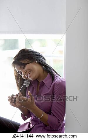 Businesswoman using mobile phone View Large Photo Image Picture - Businesswoman using mobile phone. Fotosearch