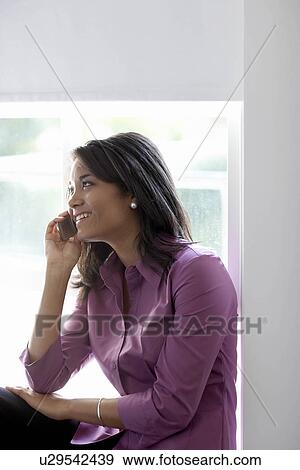 Stock Photo - Businesswoman using mobile phone. Fotosearch
