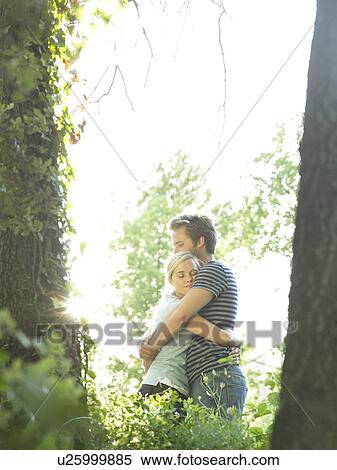 Couple hugging in woods View Large Photo Image Stock Photography - Couple hugging in woods. Fotosearch