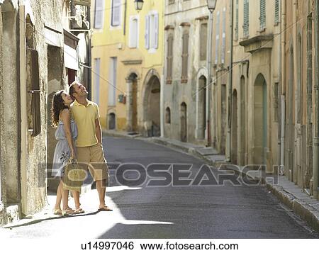 Couple in street looking up View Large Photo Image Stock Photograph - Couple in street looking up. Fotosearch
