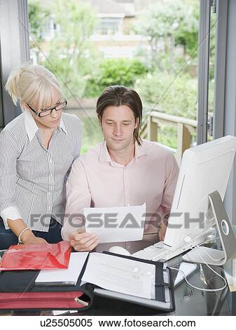 Stock Photography - Couple reading a letter together. Fotosearch