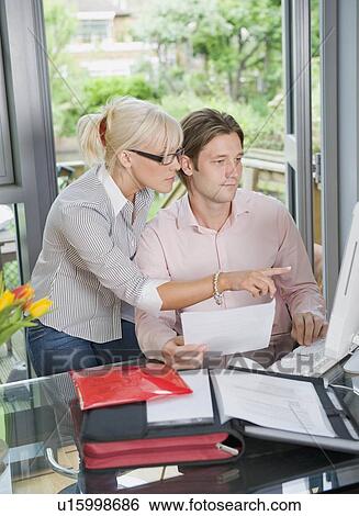 Stock Photograph - Couple working together on the computer. Fotosearch