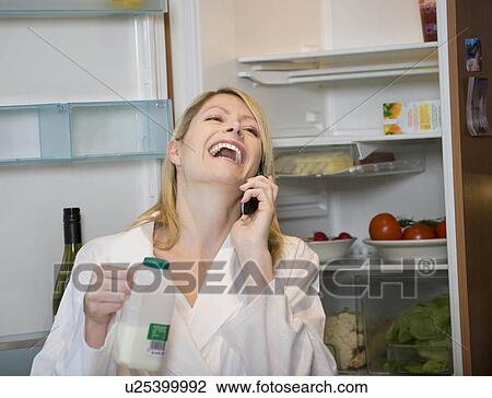 Stock Image - Female laughing on her mobile. Fotosearch