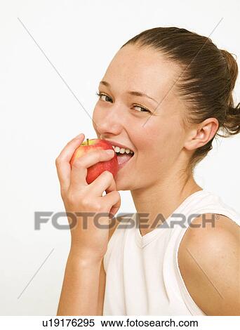 Girl eating a red apple View Large Photo Image Stock Photography - Girl eating a red apple. Fotosearch