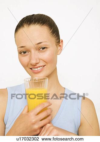 Girl holding a glass of orange juice View Large Photo Image Stock Image - Girl holding a glass of orange juice. Fotosearch