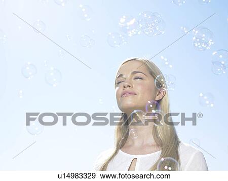 Girl in sun with bubbles View Large Photo Image Stock Photo - Girl in sun with bubbles. Fotosearch
