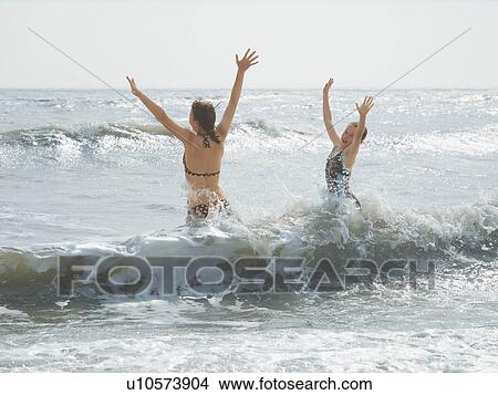 Girls jumping in the sea View Large Photo Image Picture - Girls jumping in the sea. Fotosearch