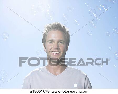 Stock Photo - Man in sun with bubbles. Fotosearch