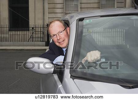 Man looking out of electric car window View Large Photo Image Stock Image - Man looking out of electric car window. Fotosearch