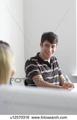 Office workers in meeting, smiling View Large Photo Image Stock Photograph - Office workers in meeting, smiling. Fotosearch