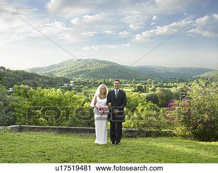 Stock Image - Wedding couple in sunlit garden. Fotosearch