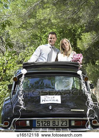 Wedding couple in wedding car View Large Photo Image Stock Photo - Wedding couple in wedding car. Fotosearch
