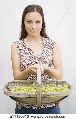 Stock Photography - Woman holding basket with berries. Fotosearch