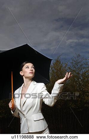 Woman under an umbrella View Large Photo Image Stock Photo - Woman under an umbrella. Fotosearch