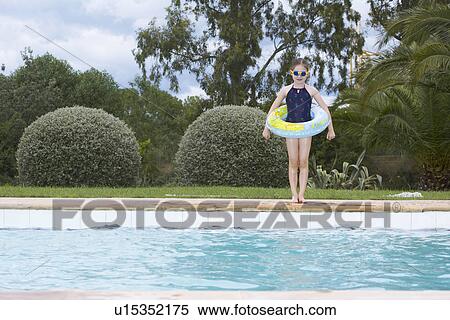 Young girl standing by swimming pool View Large Photo Image Stock Photography - Young girl standing by swimming pool. Fotosearch