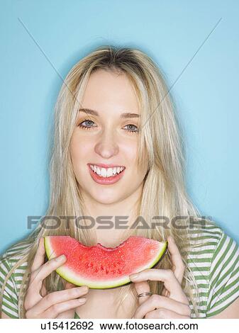 Young woman eating watermelon View Large Photo Image Stock Image - Young woman eating watermelon. Fotosearch
