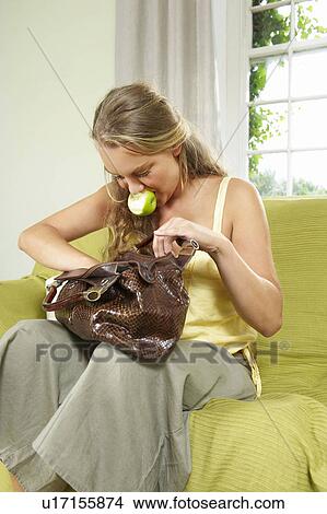 Young woman searching in handbag View Large Photo Image Picture - Young woman searching in handbag. Fotosearch