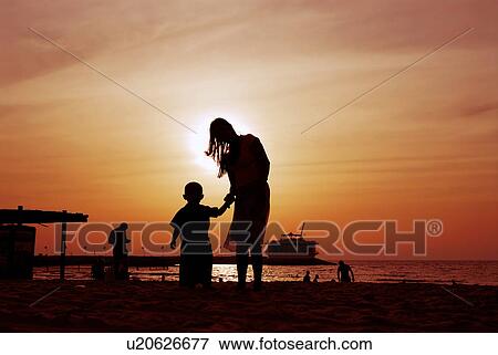 Stock Photo - sunset, sunrise, rise, dubai, beach, happy, familly. Fotosearch
