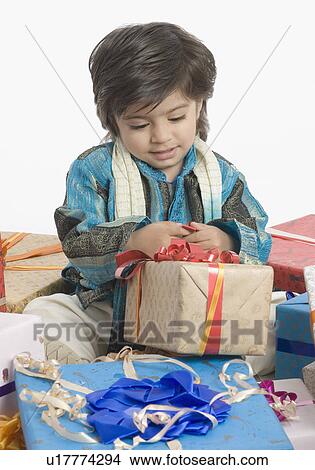 Boy opening a present View Large Photo Image Picture - Boy opening a present. Fotosearch