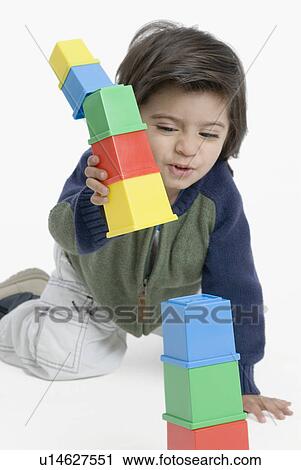 Boy playing with plastic blocks View Large Photo Image Stock Image - Boy playing with plastic blocks. Fotosearch
