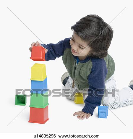 Boy playing with plastic blocks View Large Photo Image Stock Photograph - Boy playing with plastic blocks. Fotosearch