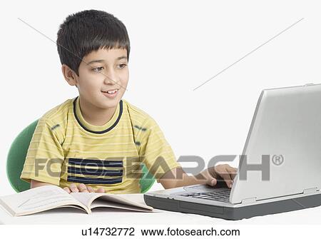 Stock Image - Boy using a laptop. Fotosearch