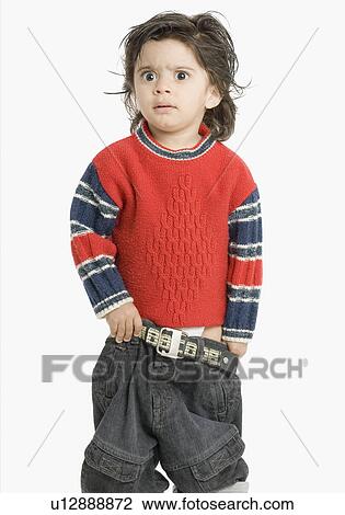 Boy wearing jeans and looking angry View Large Photo Image Stock Image - Boy wearing jeans and looking angry. Fotosearch