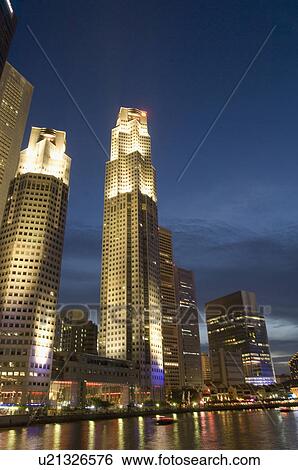Stock Photograph - Buildings lit up at night, Singapore. Fotosearch