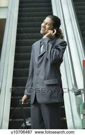 Businessman talking on a mobile phone View Large Photo Image Stock Photo - Businessman talking on a mobile phone. Fotosearch