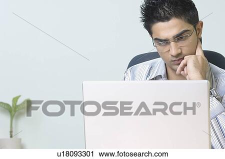 Stock Image - Businessman using a laptop. Fotosearch