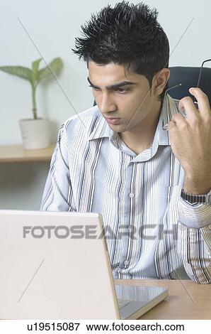 Businessman using a laptop View Large Photo Image Stock Photo - Businessman using a laptop. Fotosearch