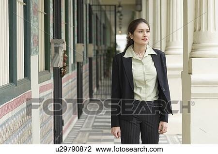 Businesswoman standing in the corridor of a building View Large Photo Image Stock Image - Businesswoman standing in the corridor of a building. Fotosearch