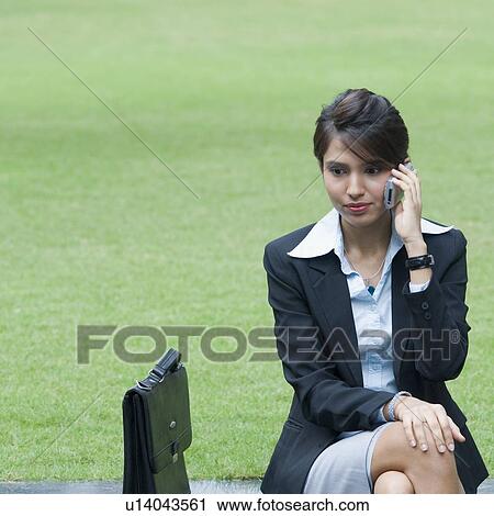 Businesswoman talking on a mobile phone View Large Photo Image Stock Image - Businesswoman talking on a mobile phone. Fotosearch