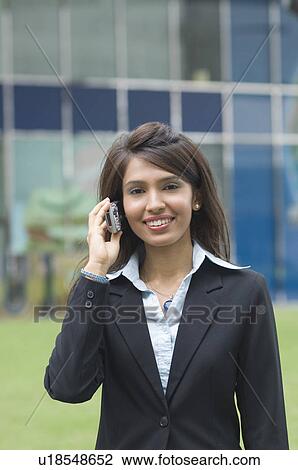 Businesswoman talking on a mobile phone View Large Photo Image Stock Image - Businesswoman talking on a mobile phone. Fotosearch