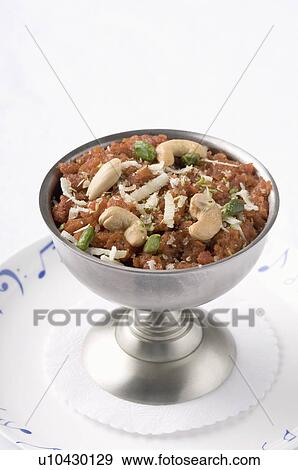 Stock Photo - Close-up of a bowl of carrot pudding on a plate. Fotosearch