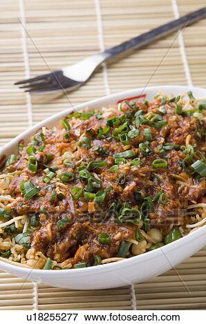 Stock Photo - Close-up of a bowl of noodles with a topping of gravy. Fotosearch