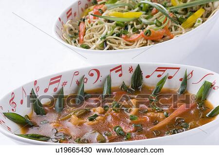 Stock Image - Close-up of a bowl of stir fried noodles with mixed vegetables . Fotosearch
