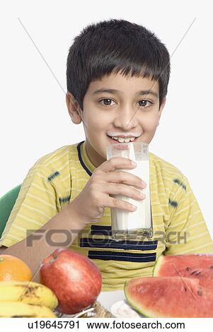 Close-up of a boy drinking a glass of milk View Large Photo Image Stock Image - Close-up of a boy drinking a glass of milk. Fotosearch