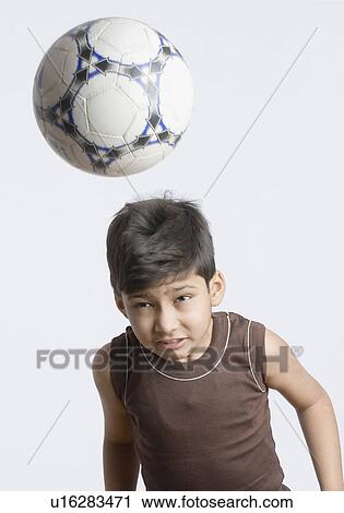 Close-up of a boy heading a soccer ball View Large Photo Image Stock Image - Close-up of a boy heading a soccer ball. Fotosearch