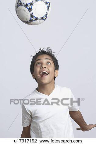 Close-up of a boy heading a soccer ball View Large Photo Image Stock Image - Close-up of a boy heading a soccer ball. Fotosearch