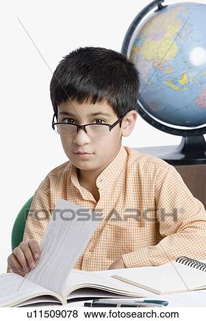Close-up of a boy holding a book View Large Photo Image Stock Photo - Close-up of a boy holding a book. Fotosearch