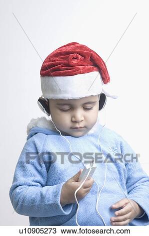 Stock Image - Close-up of a boy listening to an MP3 player. Fotosearch