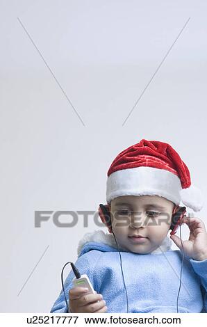 Close-up of a boy listening to an MP3 player View Large Photo Image Stock Photo - Close-up of a boy listening to an MP3 player. Fotosearch