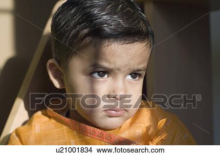 Close-up of a boy looking away View Large Photo Image Picture - Close-up of a boy looking away. Fotosearch