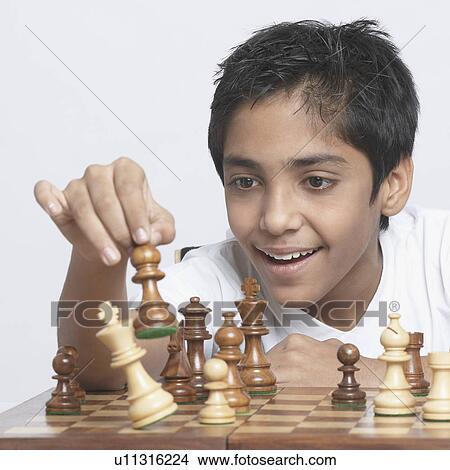 Picture - Close-up of a boy playing chess. Fotosearch